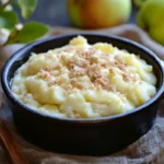 Warm custard apple crumble served in a skillet with caramel drizzle.