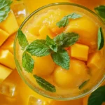 Bright and refreshing mango sorbet with mint garnish.